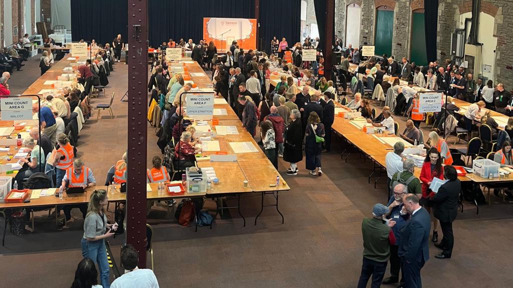 People counting votes at tables