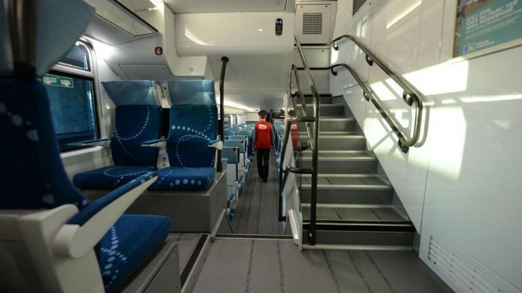 An employee of French State-owned rail operator SNCF is pictured inside a TER Regio 2N (Regio2N) train on September 15, 2014 at the St-Jean train station in Bordeaux, South-western France.