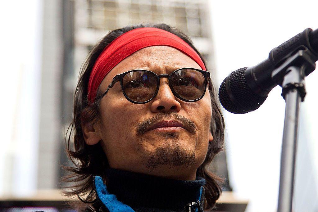 Activist Tenzin Tsundue joins Amnesty International USA, Reporters Without Borders and Committee of 100 for a peaceful protest in favor of freedom in Tibet in Times Square on March 9, 2012 in New York City. He is pictured with sunglasses and a red bandana.