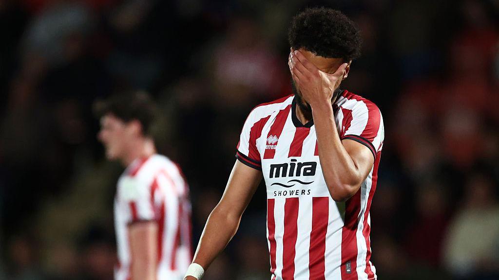 Lee Angol of Cheltenham Town reacts during the Vertu Trophy group stage match between Cheltenham Town and Bristol Rovers