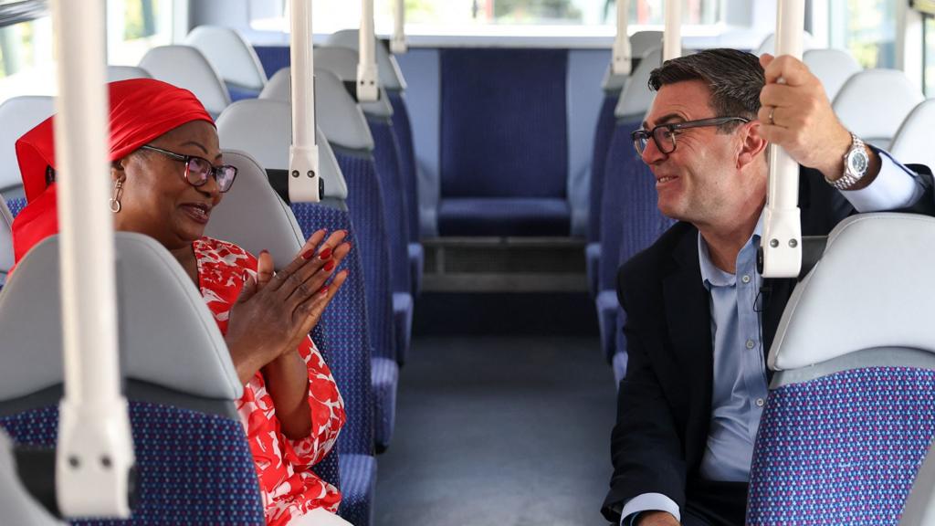 Andy Burnham sits on a bus and speaks to a TikTok influencer known as London Bus Aunty