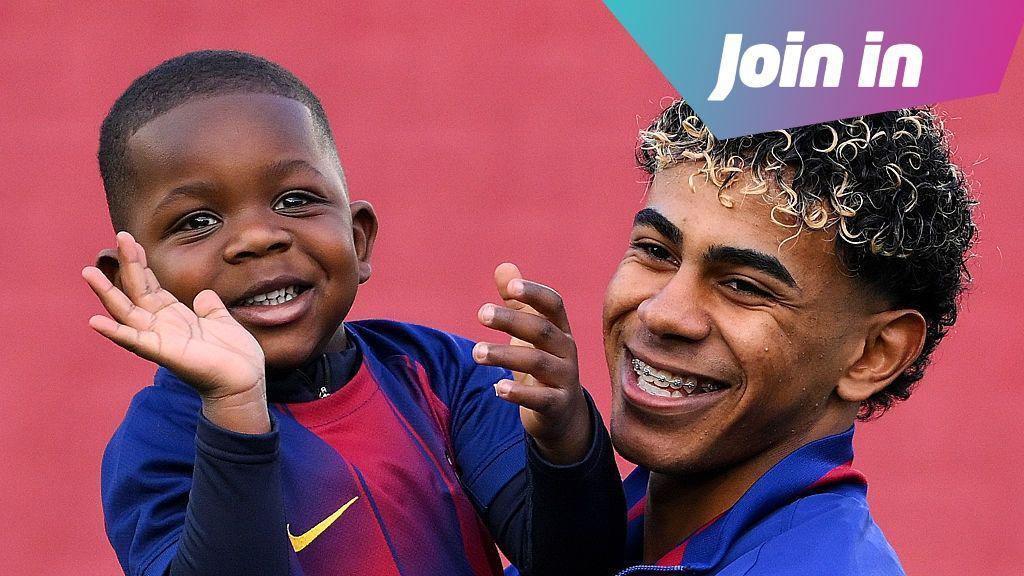 Lamine Yamal and his brother Keyne smiling. Yamal has braces and curly black hair with blonde tips. Keyne has short black hair. They are both wearing FC Barcelona kits that are blue and red.