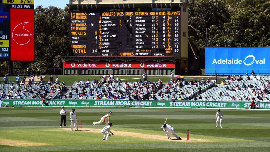 Australia's Pat Cummins (3/L) fells India's Mohammed Shami (2/R) with a bouncer as India is dismissed for only 36 runs on the third day of the first cricket Test match between Australia and India played in Adelaide on December 19, 2020. (