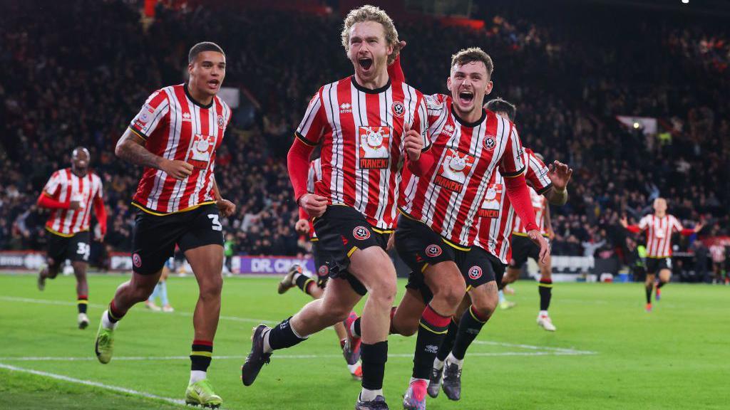 Sheffield United players celebrate scoring a goal against Sunderland