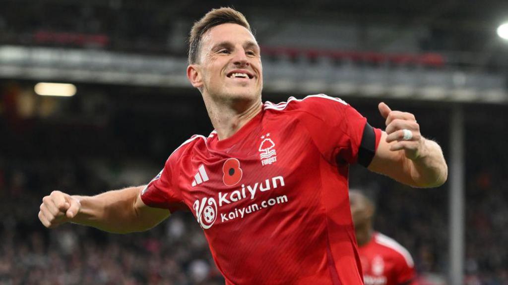 Chris Wood wearing a red Nottingham Forest shirt