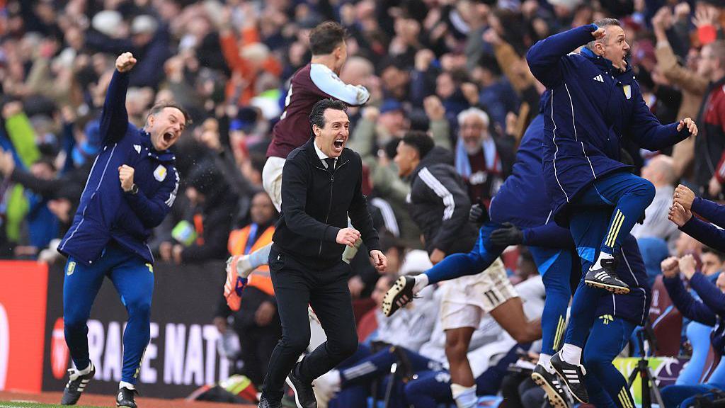 Aston Villa manager Unai Emery celebrates the late winning goal with his coaching staff and players