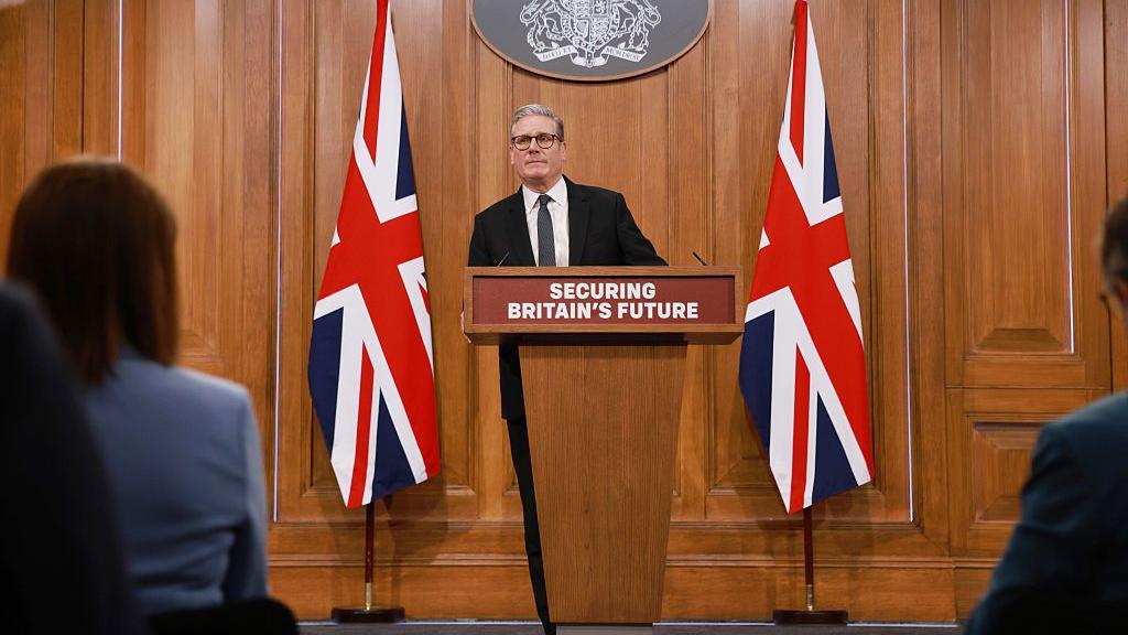 Sir Keir Starmer addressing journalists from a podium in Downing Street
