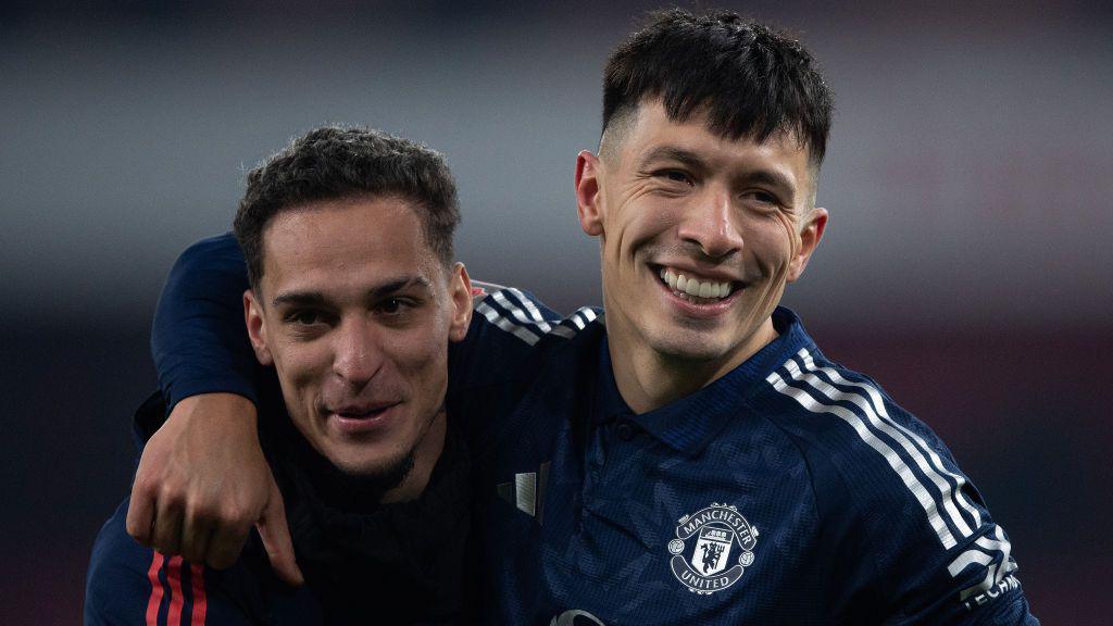 Antony and Lisandro Martinez smile arm in arm