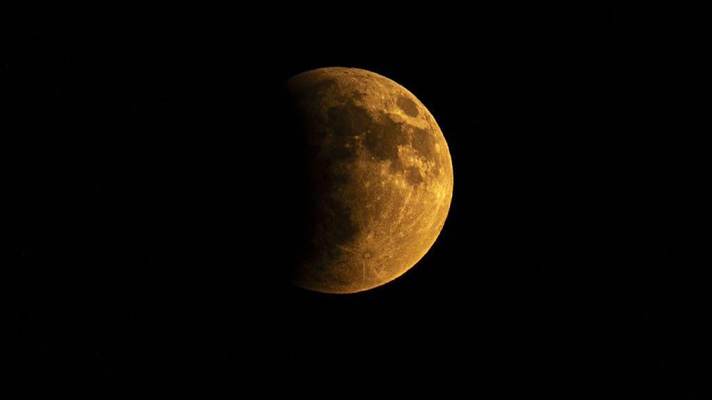 The Blood Moon emerging in a dark sky
