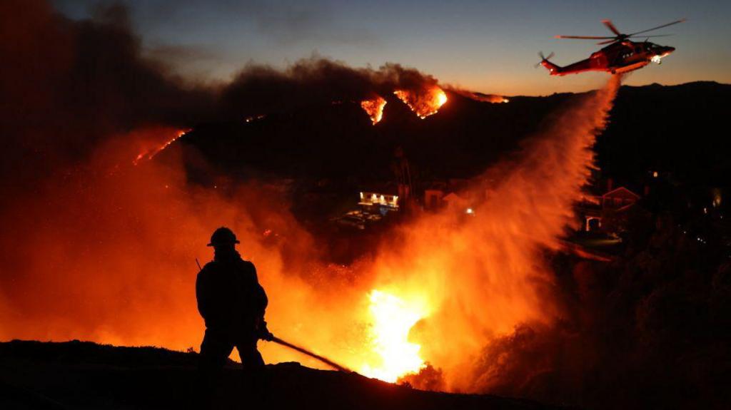 firefighter and helicopter putting fire out in LA