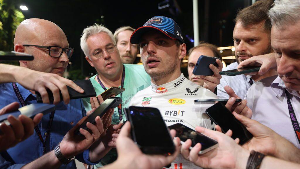 Max Verstappen is surrounded by journalist as he conducts a news conference in the paddock in Singapore last year 