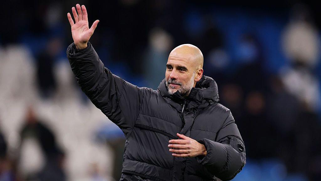 Pep Guardiola waves to crowd after match