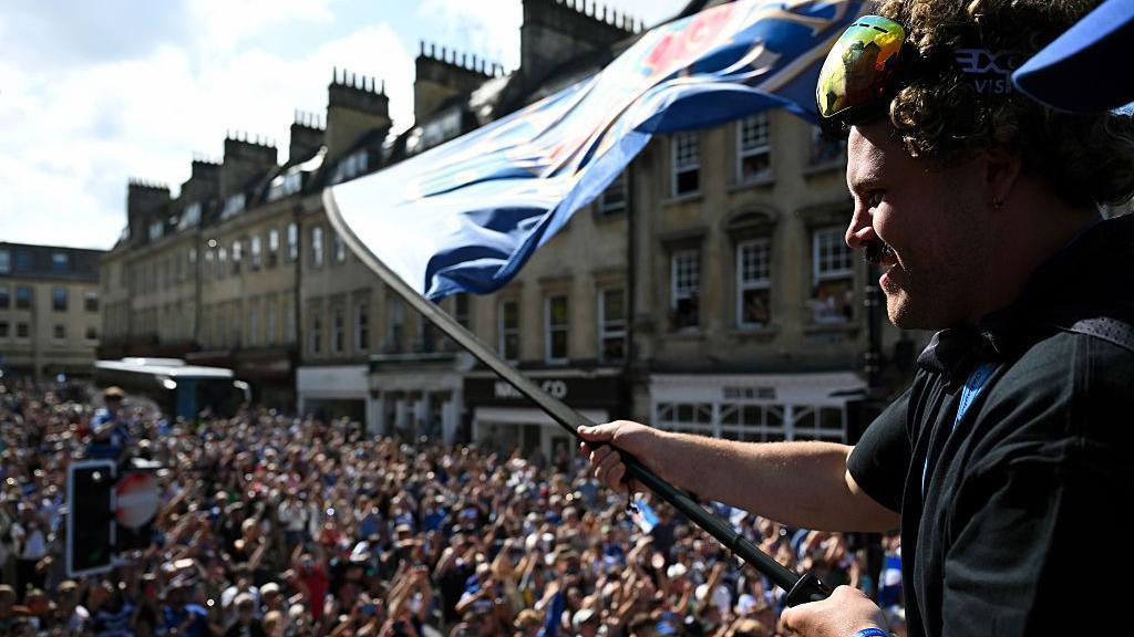 Alfie Barbeary waves a Bath flag