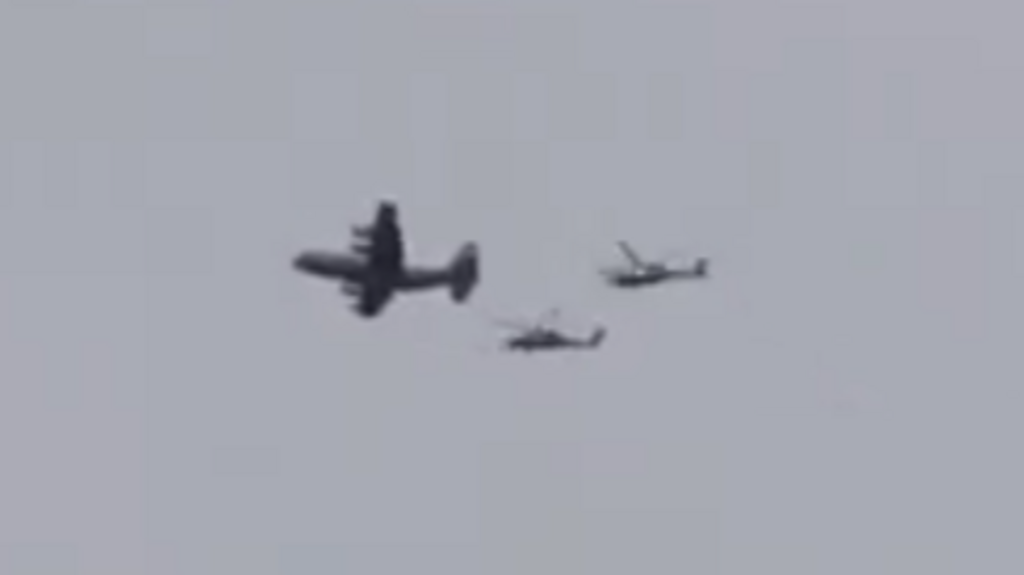 A still of a video showing what appears to be a US plane accompanied by two helicopters flying over southern Iran