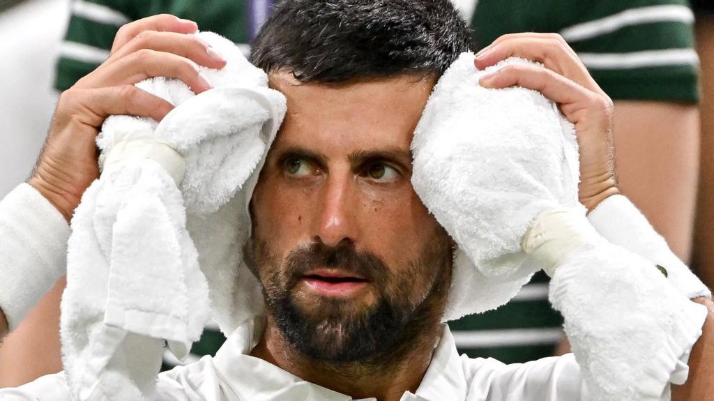 Djokovic Battles Through Aches to Advance to Round Two