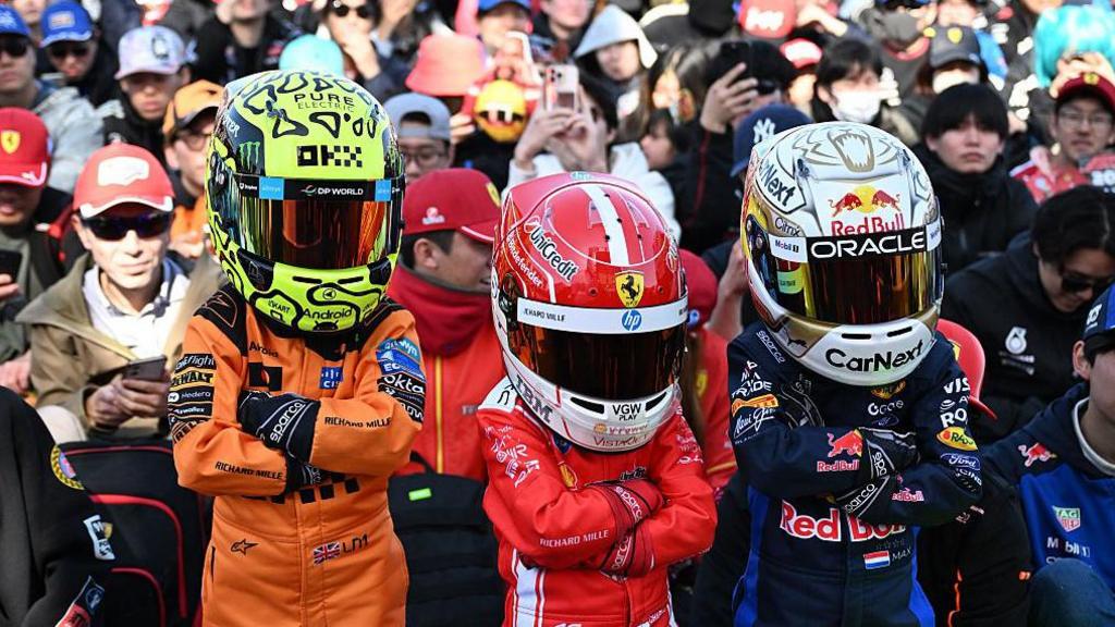 Young fans wearing the race suits and helmets of their favourite drivers at the Japanese Grand Prix