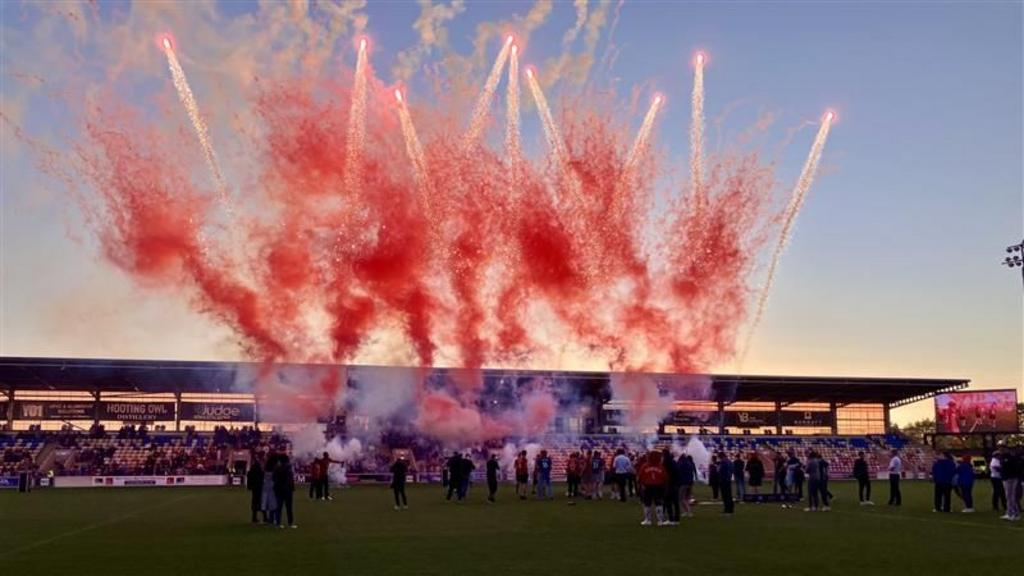 The York City squad with fireworks in the background