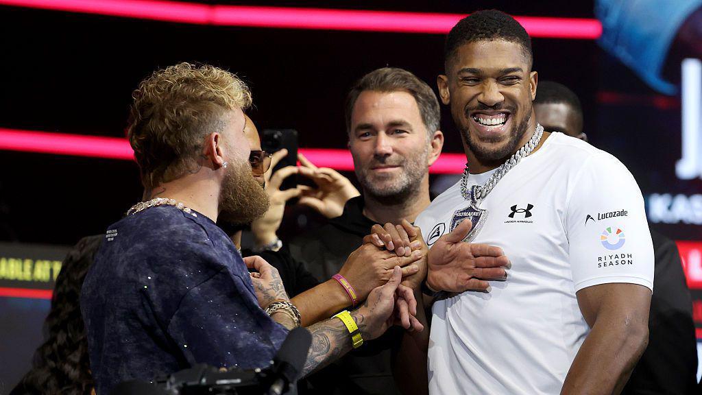 Anthony Joshua laughs as he faces off with Jake Paul