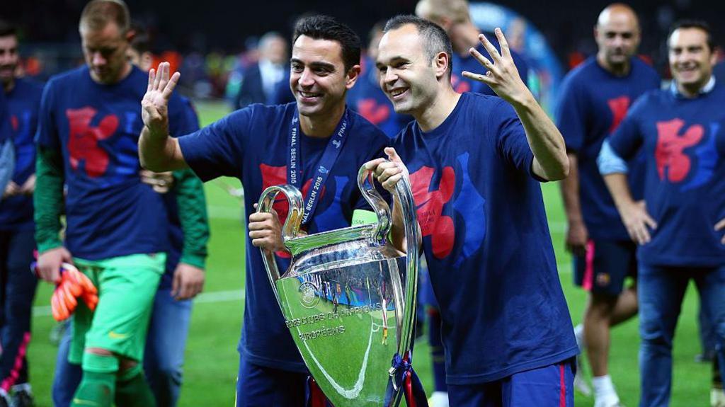 Xavi and Andres Iniesta celebrate with the Champions League trophy