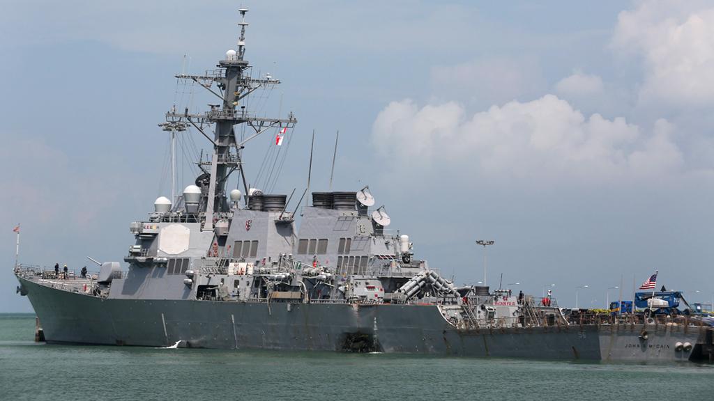 A handout photo made available by the United States Navy 7th Fleet shows the damaged port side of the United States Navy missile destroyer USS John S McCain while berthed at the Changi Navy Base in Singapore.