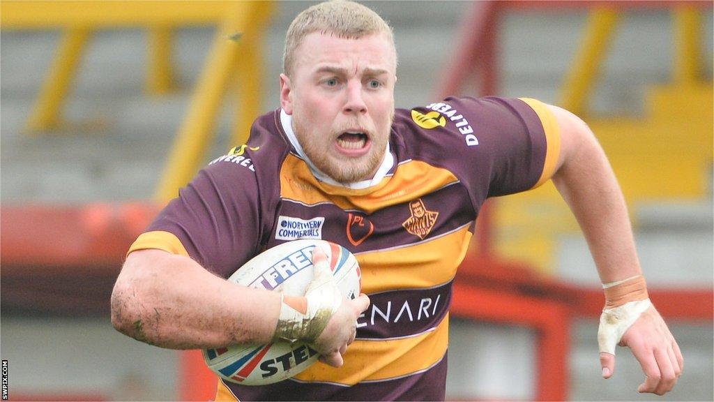 Jack Ashworth powers forward for Huddersfield in a friendly against Dewsbury