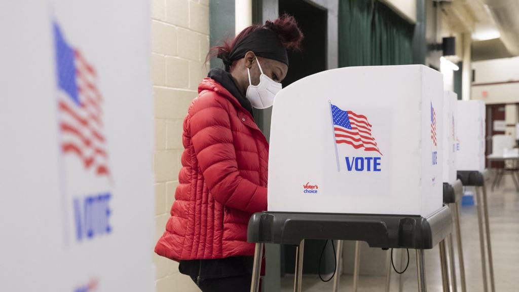 A person stands in a voting booth at a polling location inside Show Place Arena in Upper Marlboro, Maryland, USA, 2 November 2020