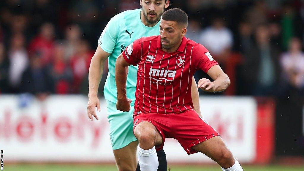 Liam Sercombe with the ball for Cheltenham during their game against Exeter this season