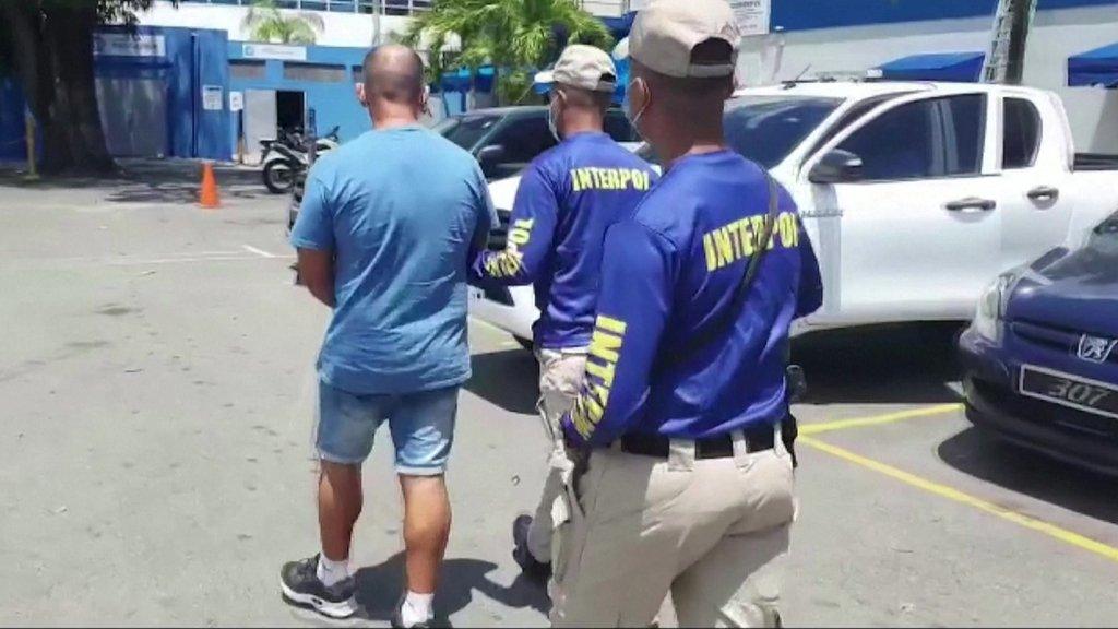 A man being led away by police