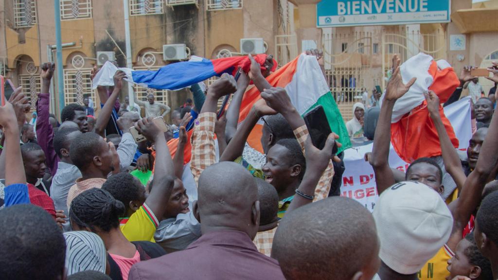 Supporters of the coup in Niger holding flags aloft - 27 July 2023