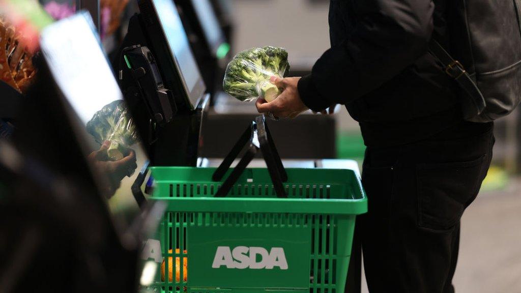 Shopper using a self-checkout at an Asda Express convenience store