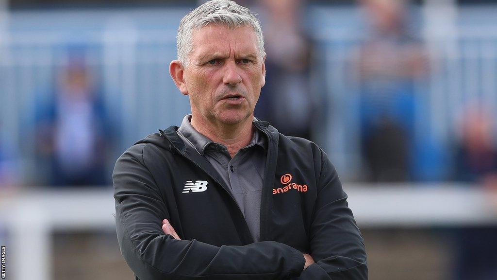 Hartlepool United manager John Askey, with his arms folded, oversees a training session before a National League match