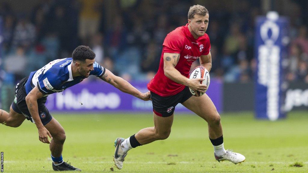 Brendan Owen (right) runs with the ball as he is grabbed by a Bath player during their Premiership Rugby Cup match