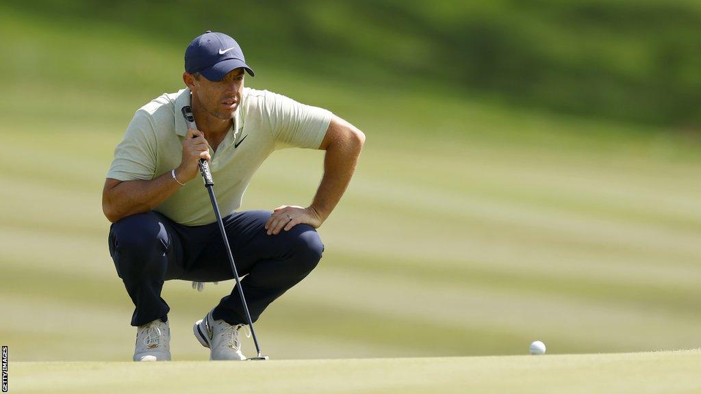 Rory McIlroy lines up a putt