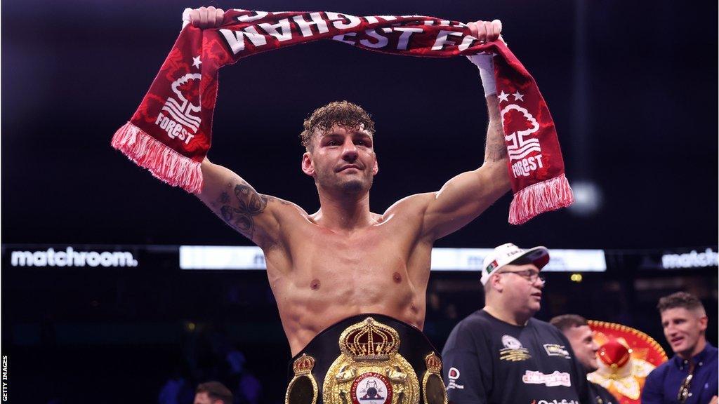 Leigh Wood holds a Nottingham Forest scarf in the ring after reclaiming his WBA belt