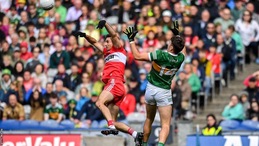 Chrissy McKaigue beats David Clifford in the air at Croke Park