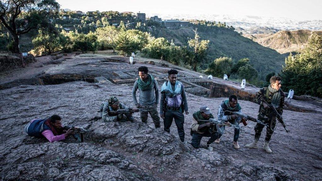 File pic of Amhara Fano militia fighters pose at Saint George Church in Lalibela, in 2021