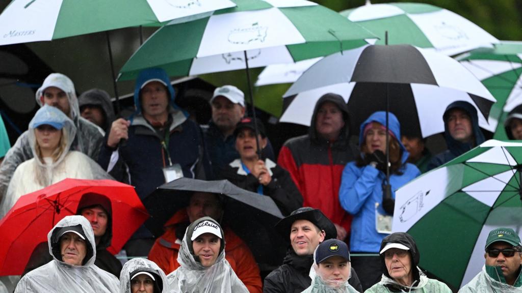 Patrons with umbrellas at the Masters