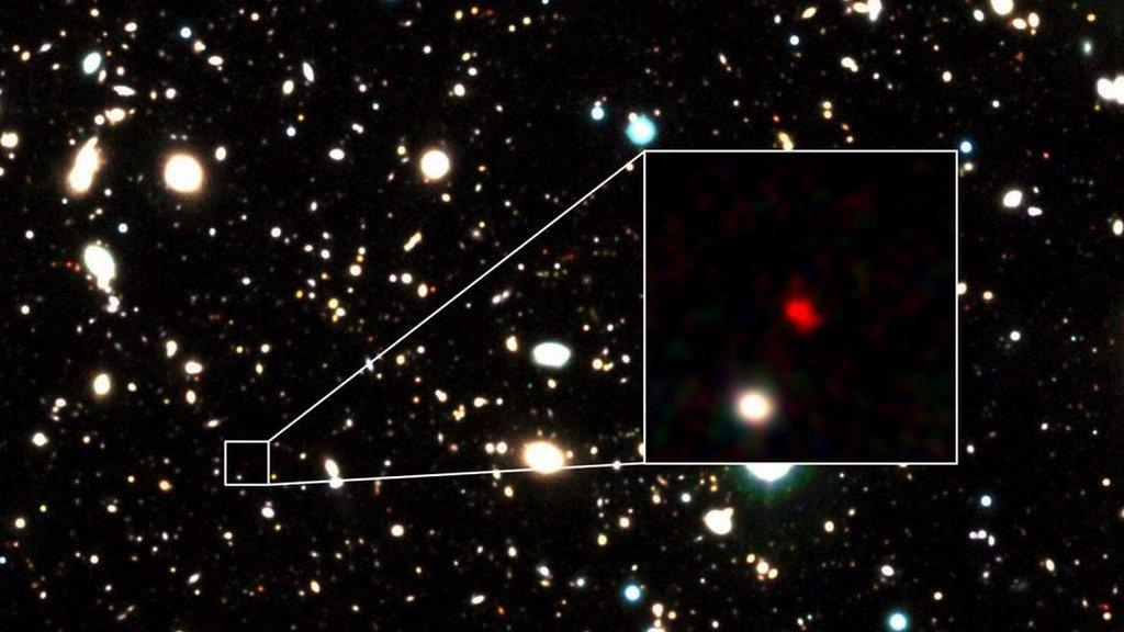 he distant early galaxy HD1, object in red, is shown at the center of this undated zoom-in handout image.