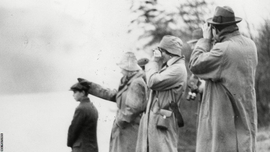 Onlookers try to spot the Loch Ness monster in 1934