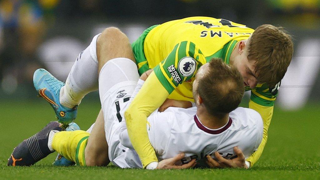 Brentford's Christian Eriksen and Norwich's Brandon Williams share a hug