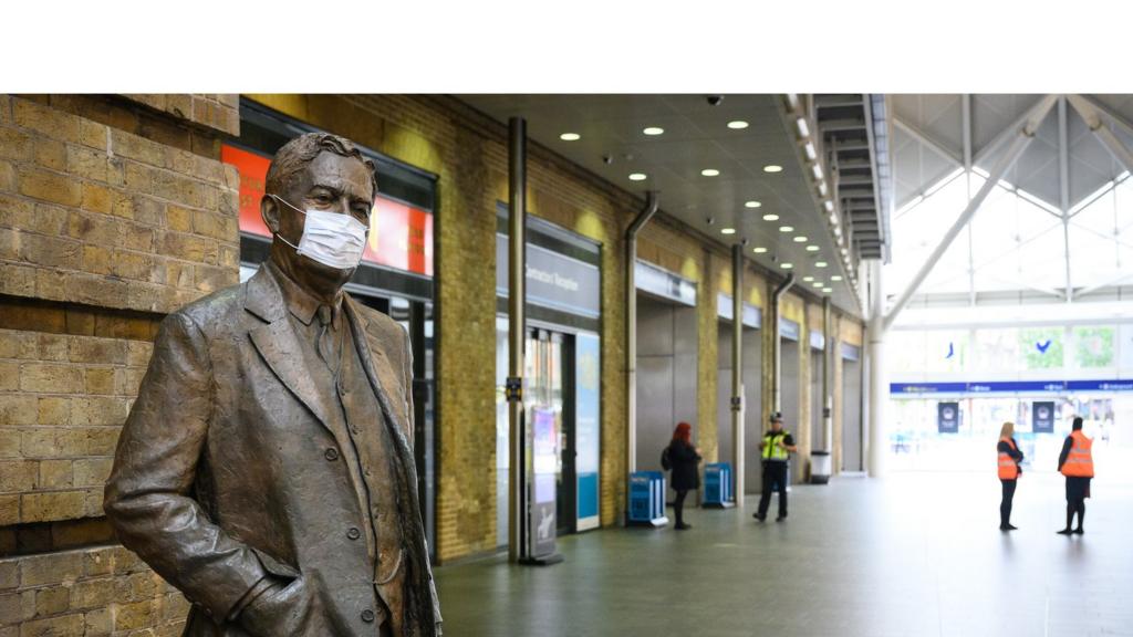 A protective face mask is seen on a statue of Nigel Gresley, the Chief Mechanical Engineer for the Great Northern Railway and the London ^ North Eastern Railway with Kings Cross station, on June 08