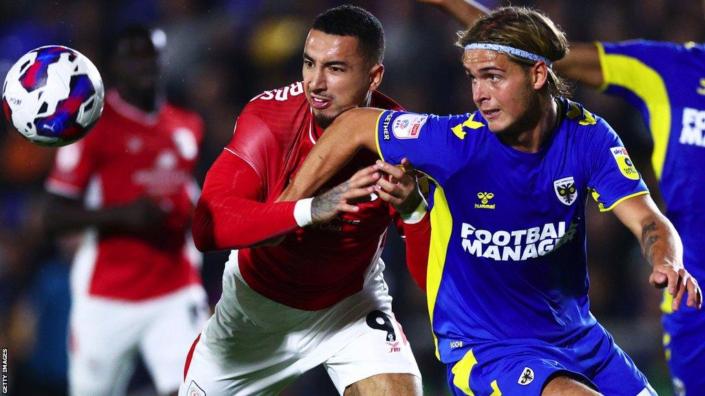 Ryley Towler (right) in action for AFC Wimbledon