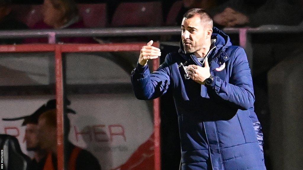 Reading manager Ruben Selles instructs his players from the dugout during a League One game.