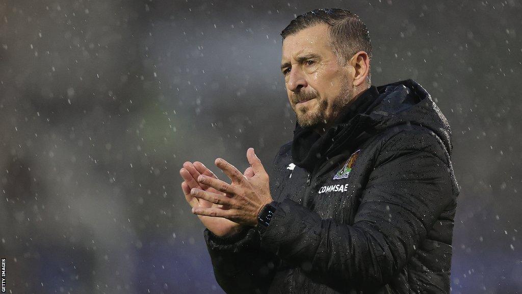 Northampton Town manager John Brady claps the fans