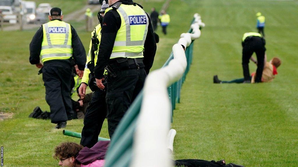 Police deal with protestors at the Ayr track