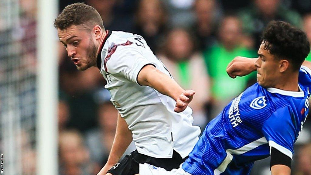 Alex Robertson of Portsmouth (right) tackles Elliot Embleton of Derby County