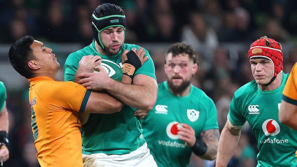 Ireland's Caelan Doris is held up by Australia's Len Ikitau at the Aviva Stadium