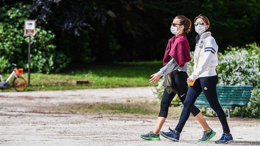 Woman walk in park in Milan