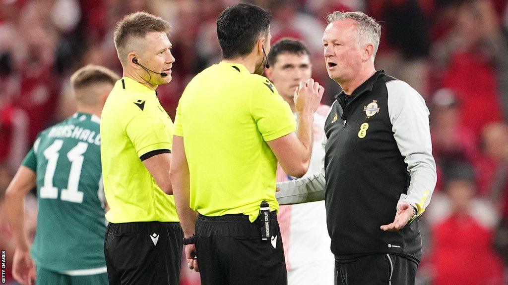 Northern Ireland manager Michael O'Neill in discussion with referee Daniel Stefanski after the match in Copenhage