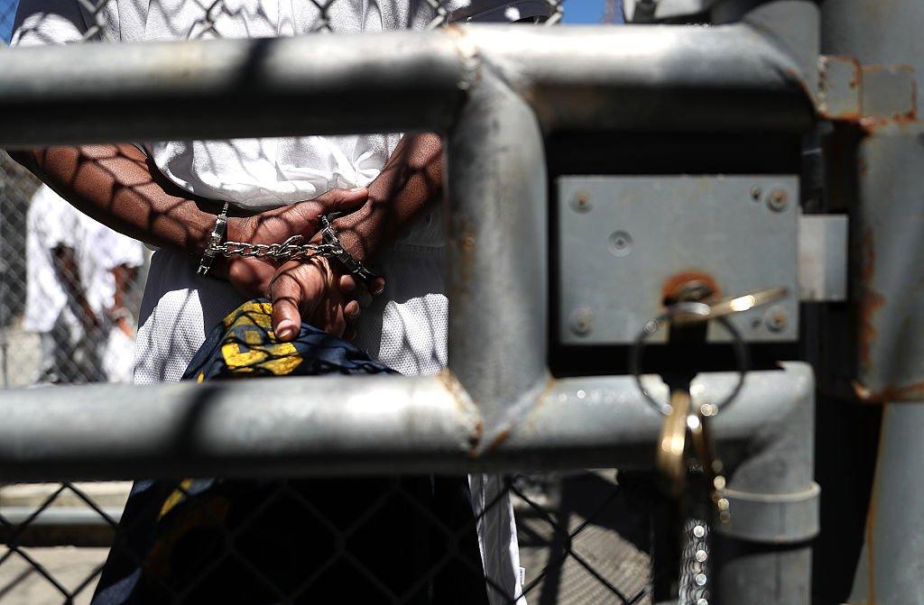 An inmate stands with handcuffs at San Quentin State Prison in California.